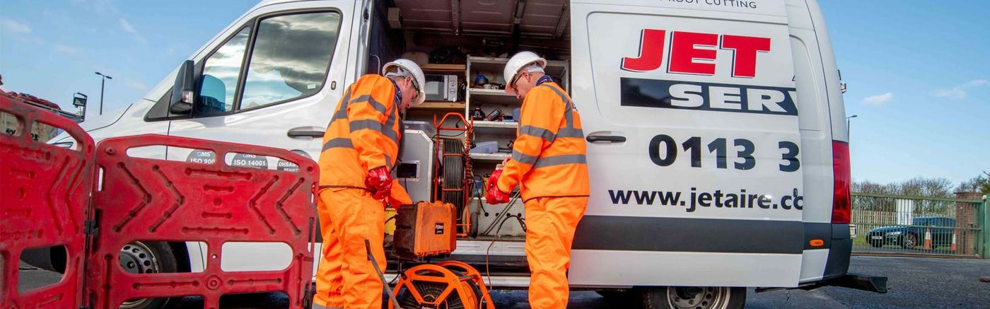 Jet Aire engineers working beside a branded van