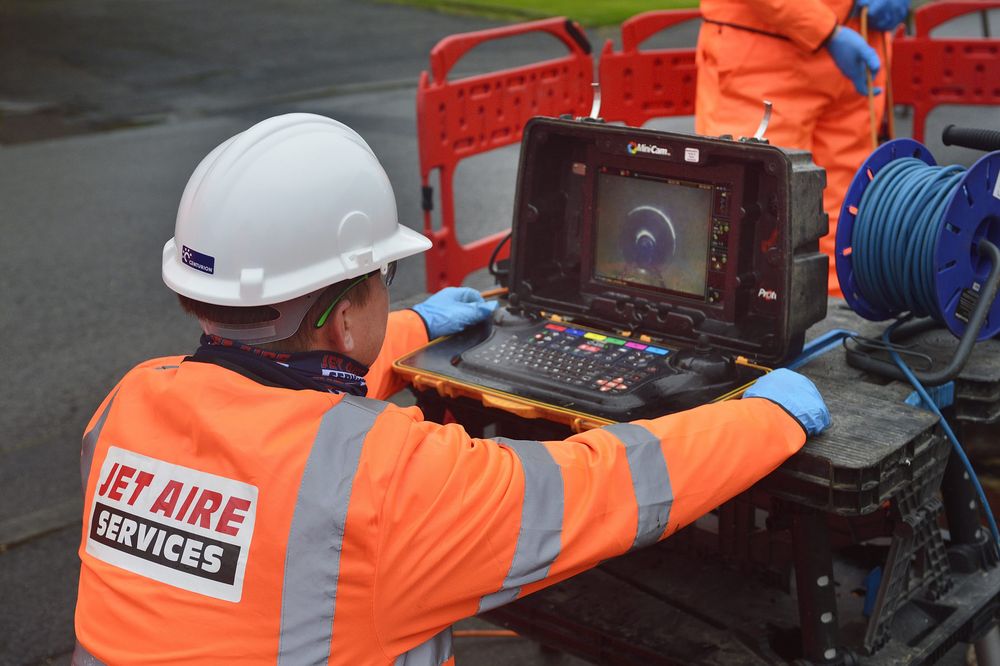 A Jet Aire engineer reviewing CCTV footage in a survey van